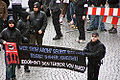Autonome Nationalisten/Autonomous Nationalists at a 2006 protest. The black and red flags on the banner are of the Antifaschistische Aktion's logo