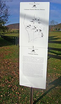 A white rectangular sign with a map and explanatory text on it headed by "Coleman Station Historic District