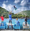 A kiteboarder soars over cheering fans at Saba Rock Resort, British Virgin Islands