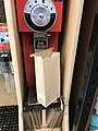 Coffee grinder at grocery store with a paper bag for ground coffee
