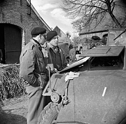 Major-General Christopher Vokes in discussion with Brigadier Robert Moncel standing in a street in Sögel on 10 April 1945