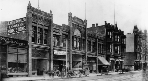 Panorama Building, E side of Main between Mayo (3rd) and 4th, c. 1890. The center entrance led through to the panorama exhibition space in the back. Note the Olmsted & Wales Panorama Bookstore, and the offices of the Evening Express. At right, the Hotel Westminster at the NE corner of 4th/Main.