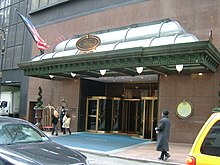Entrance of the hotel from 51st Street, with cars in front