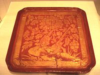 A Chinese red lacquer tray over wood with engraved golden foil, from the Song dynasty (960–1279 AD), dated 12th to early 13th century. Freer and Sackler Galleries, Washington D.C.
