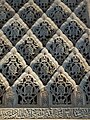 Sebka motif filled with arabesques in the carved stucco decoration of the Cuarto Real de Santo Domingo in Granada, Spain