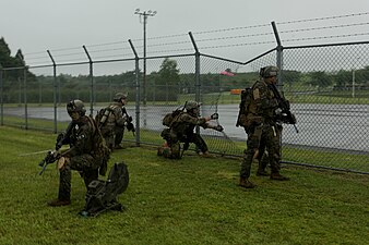 Maritime Raid Force, 31st Marine Expeditionary Unit, provide security outside of a breached fence during a raid