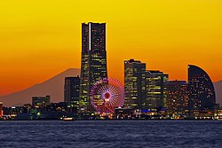 Minato Mirai 21 commercial area is located between Nishi and Naka districts, Yokohama city, Kanagawa prefecture at sunset. Mount Fuji appears on the horizon