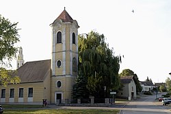 The preserved tower of Platt's old parish church. The new church is visible in the background on the left