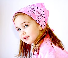 girl wearing a pink bandanna over her hair