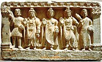 Early Mahayana Buddhist triad. From left to right, a Kushan devotee, Maitreya, The Buddha, Avalokiteśvara, and a Buddhist monk. 2nd–3rd century, Gandhara.