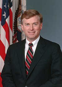 A colored photograph of a man, Dan Quayle, wearing a suit