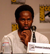 Harold Perrineau behind the microphone at a convention.