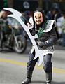 A person in Klingon costume with a bat'leth