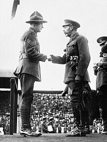 Two men in military uniforms shaking hands