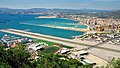 Image 12Gibraltar Airport and border area. Showing runway (Gibraltar) and pier behind (Spain). Officially, any exact line is still disputed (from Transport in Gibraltar)