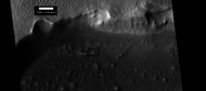 Crater wall and floor in Lycus Sulci, as seen by HiRISE under HiWish program. The crater floor contains many mounds and ridges. The part in the box is enlarged in the next photo.