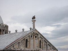 A copy of the bronze Pisa Griffin in its original position on the cathedral roof