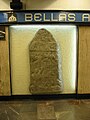 Replica of a gravestone from Izapa, Chiapas located in Metro Bellas Artes in Mexico City. The accompanying plaques translates to "Gravestone of Izapa – Mayan culture – Preclassic Period – Description: Bas relief from Izapa depicting a person loading something."