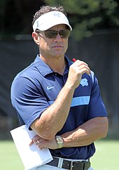 Coach Fedora wearing a visor and sunglasses.