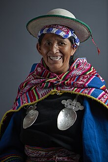 Full-body shot of Lidia Patty adorned in Kallawaya traditional regalia.