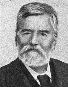 Black-and-white photograph of an elderly, bearded man.