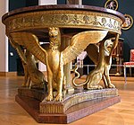 A table with three winged lions and a small long frieze with palmettes