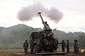 The crew of a Philippine Army ATMOS 2000 self-propelled artillery firing a 155 mm shell