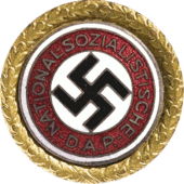 a circular golden badge with a central swastika