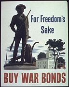 A white propaganda poster. On the right is a brown statue of a man in 18th-century clothing. He holds a rifle, and his coat is on a plow beside him. Behind the statue is (from left to right) a church spire, a New England-style meetinghouse, and a colonial house. In the right is printed in blue "For Freedom's Sake" and at the bottom is printed in red "Buy War Bonds".