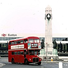 Obelisk with red bus in front
