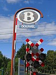 Bouwel station with B logo with level crossing signs