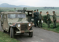 Members of the 11th Armored Cavalry stop to talk with West German border police while patrolling the border between East and West Germany in M151 light vehicles.