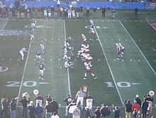 Two football teams on the field in position prior to the play