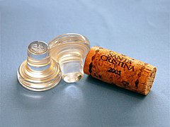 Glass stoppers for wine bottles and a cork stopper.