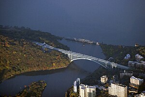 An aerial view showing the Henry Hudson Bridge (foreground) and the Spuyten Duyvil Bridge