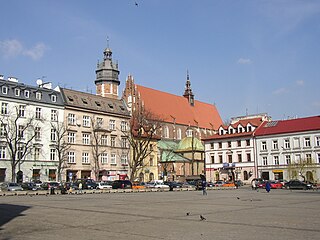 Plac Wolnica, a central market square in the Kazimierz district. The Polish Gothic Corpus Christi Basilica can be seen in the background.