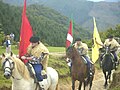 Riders with the Flag of Navarre, ikurrina and the Arrano beltza.