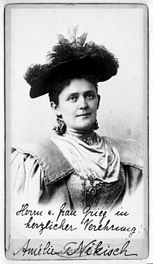 An autographed photograph, featuring a white woman wearing a plumed hat