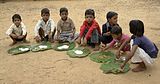 K4. Children in Chambal, Madhya Pradesh, eating puri and kheer at school.