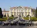 The front façade of the Queluz National Palace with ornate water fountain