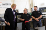 President Donald J. Trump prepares to sign a worker's hat while visiting with employees during his tour of the Sheffer Corporation, Monday, February 5, 2018, in Blue Ash, Ohio.