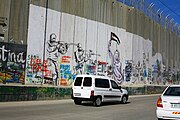 Mural of two IDF soldiers aiming at a Palestinian woman