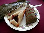 Glutinous zongzi rice dumplings, without and with bamboo leaf wrapping