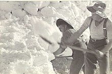 Men clearing snow with shovels