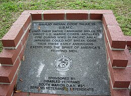 Code talker memorial with etched words: "Navajo Indian Code Talkers USMC. They used their native language skills to direct the US Marine Corps Artillery fire during WWII in the Pacific area. Japanese could not break the code. Thus, these early Americans exemplified the spirit of America's fighting men. Sponsored by: Disabled Veterans South Marion DAV#85 serving veterans and dependents." The memorial also includes the United States Marine Corps emblem.