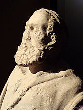 Head and upper body of a statue depicting an old man with a large beard. Minimal damage includes a missing nose.