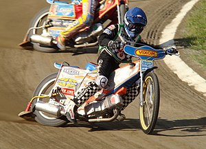 Łukasz Sówka broadsides round a bend in a speedway race.