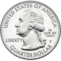 Quarter with profile of Washington bust. He faces left regally and wears a colonial-style queue in his hair. "UNITED STATES OF AMERICA" is at top, "QUARTER DOLLAR" at bottom, "LIBERTY" at left, and "IN GOD WE TRUST" above "P" at right. Just below the bust is "JF uc" in tiny letters.
