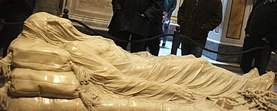 Dead Jesus Christ lying on a couch under a shroud