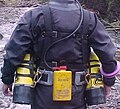 Back view of the modified British sidemount harness with cylinders, weights and battery pack.
